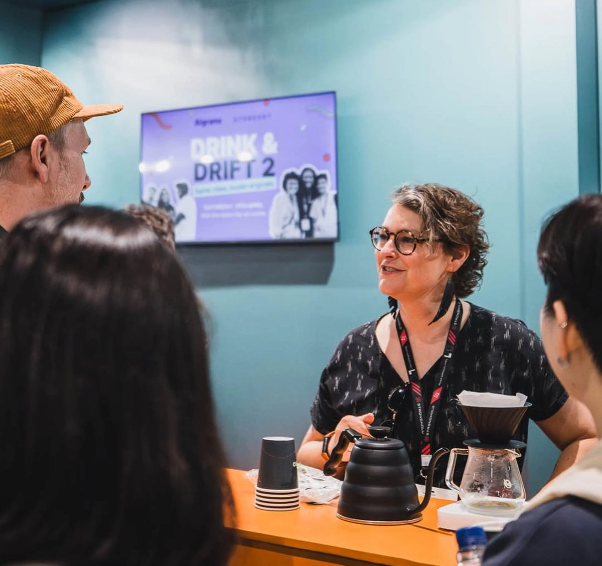 Sarah Rice Scott, Director of Coffee talking with conference attendees at World of Coffee
